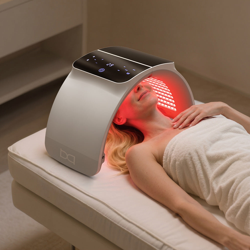 Person has red light therapy at home with BestQool 7 Color Photon LED device for SPA skincare.