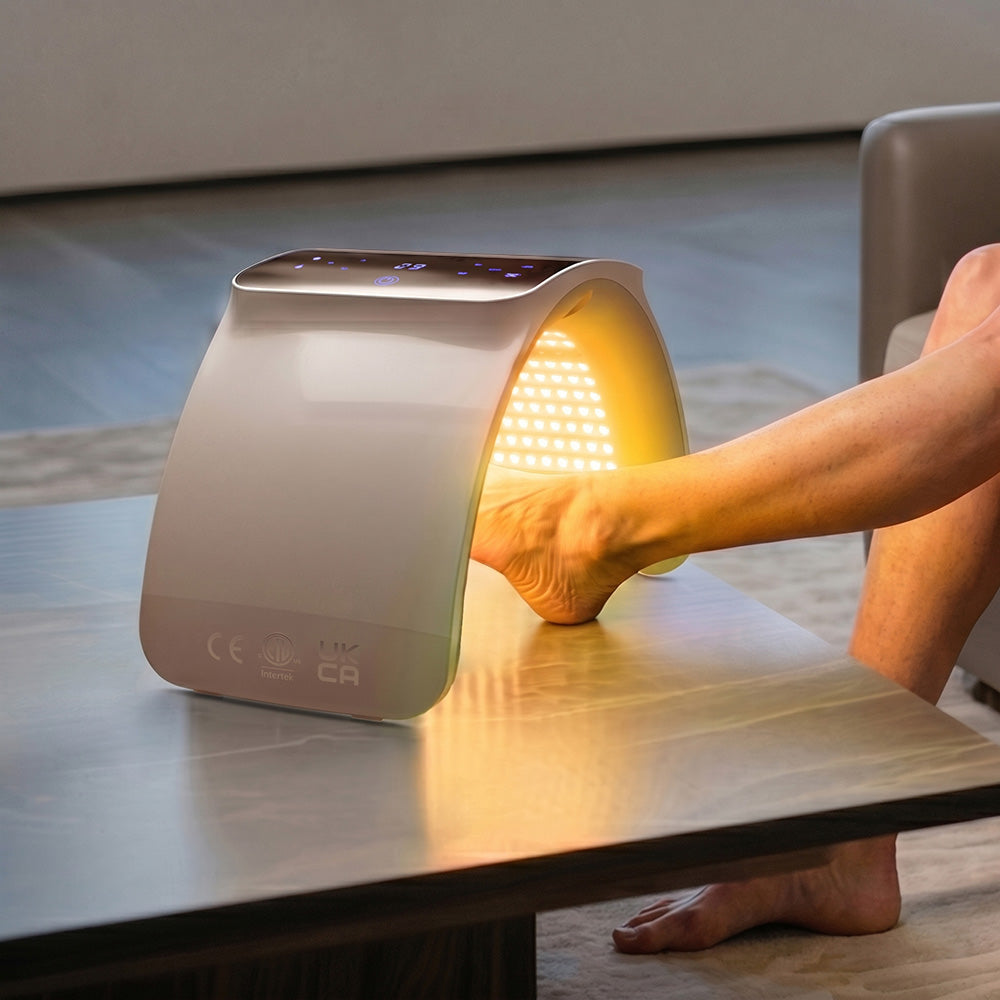 Person receiving yellow light therapy from an arched BestQool 7 Color Photon LED device for foot skin use.