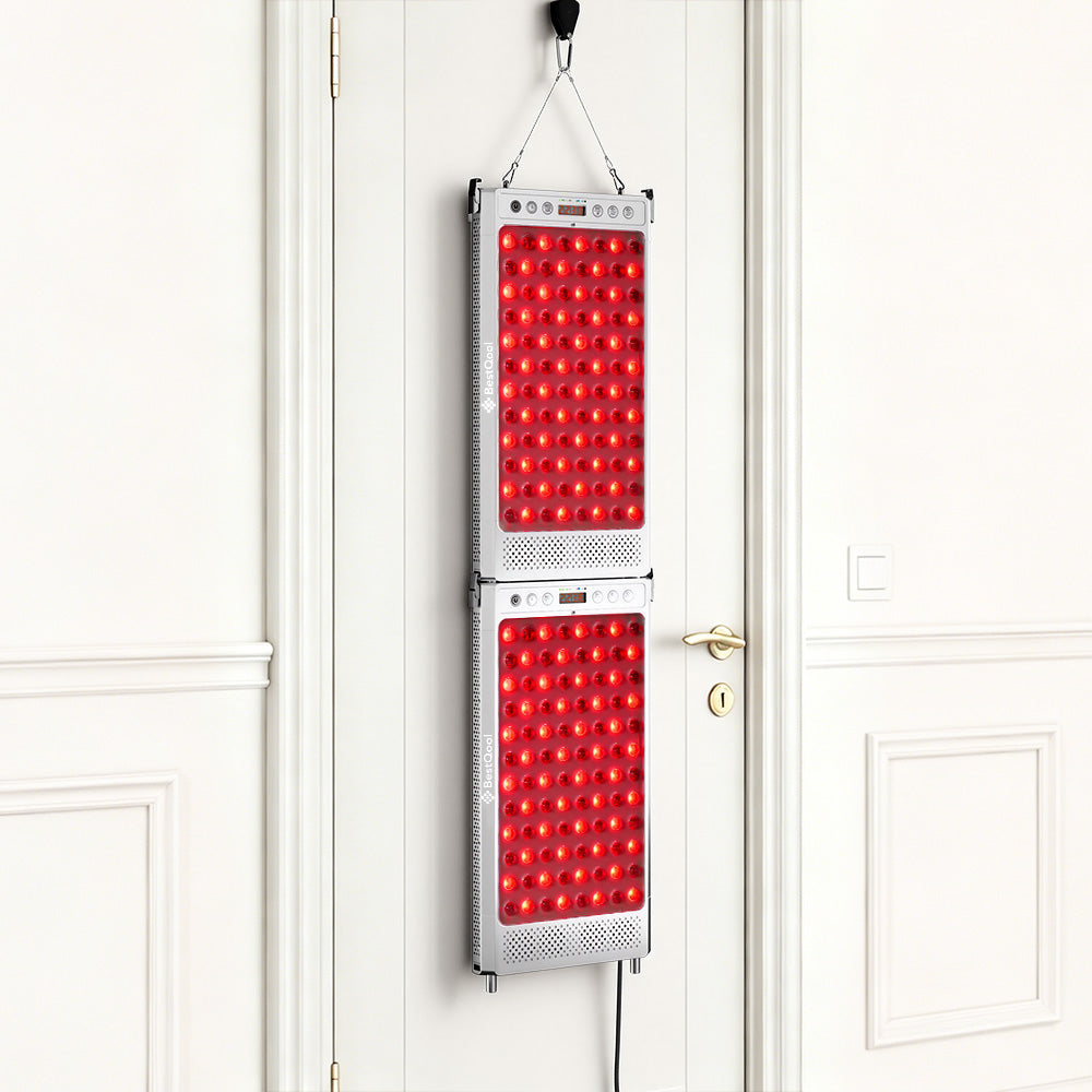 Two connected BestQool IPX6 red light therapy panels hanging over a white door for full-body treatment.