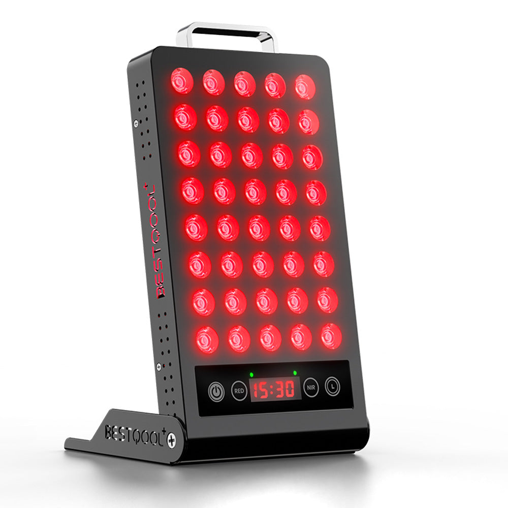 User engaging in red light therapy with portable BQ40 device on a desk.