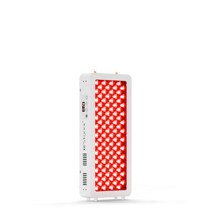 Man reading beside Half-Body Red Light Therapy Pro100 emitting therapeutic red light.
